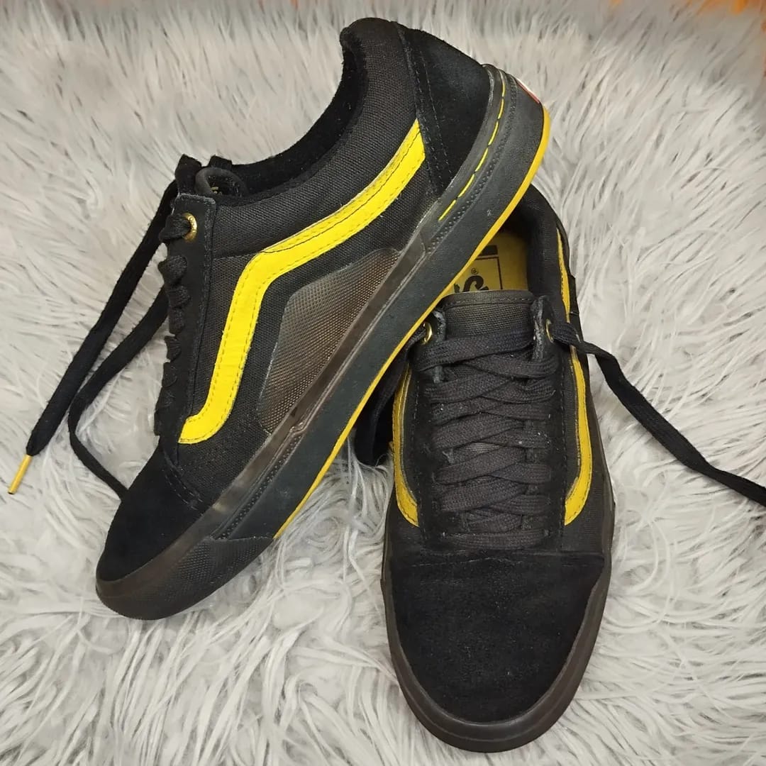 Black and gold low rise vans