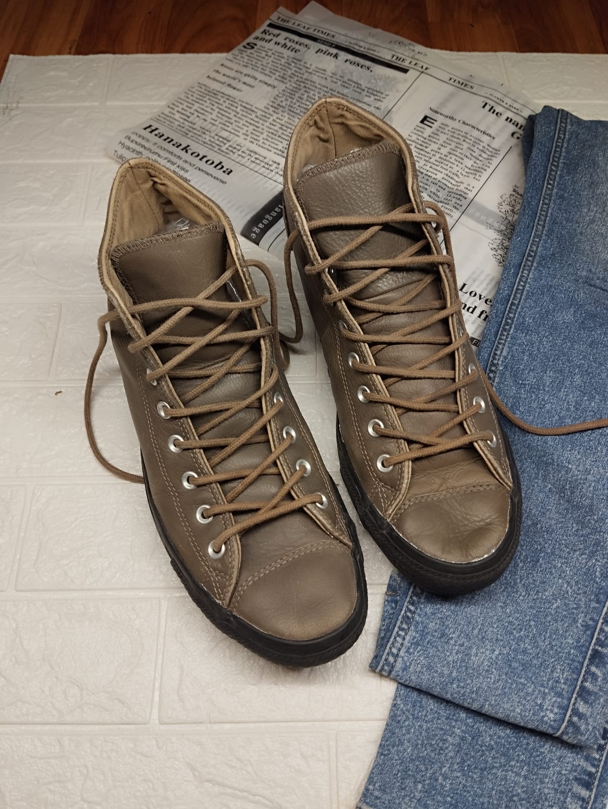 Brown and black leather high rise converse
