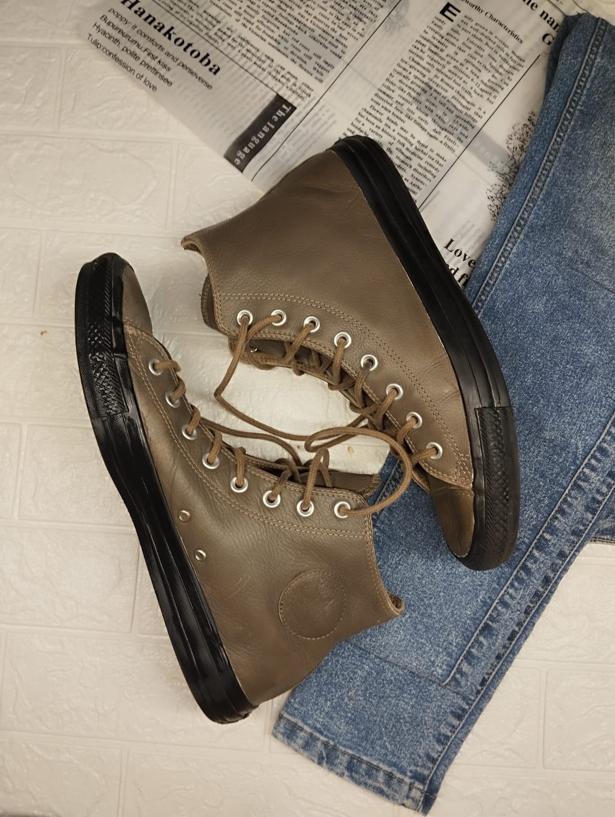 Brown and black leather high rise converse