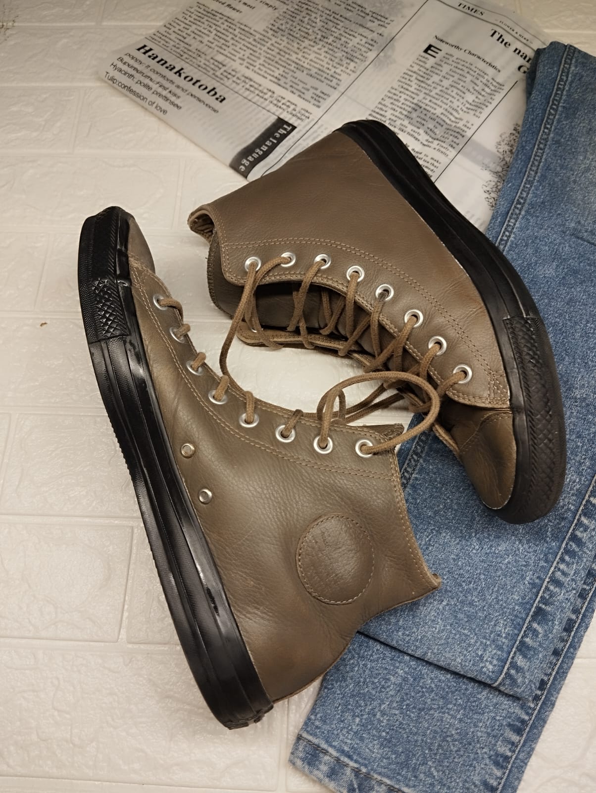 Brown and black leather high rise converse
