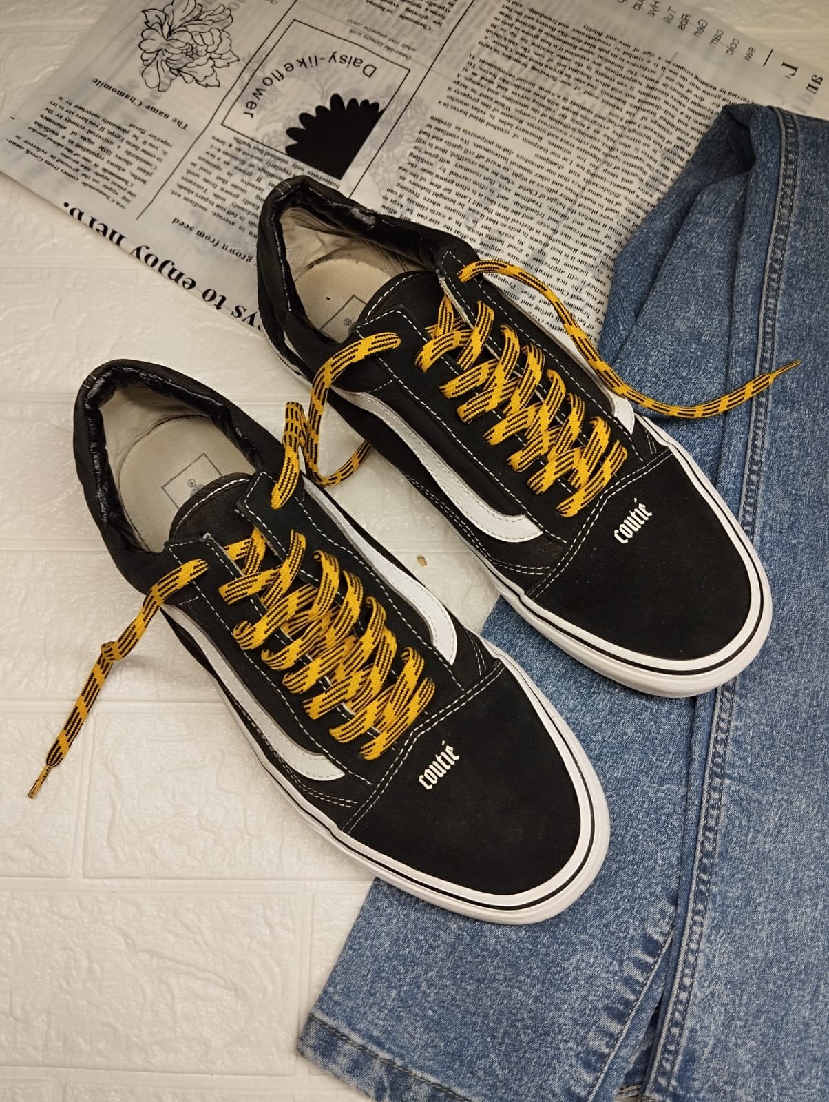 Black and yellow low rise vans