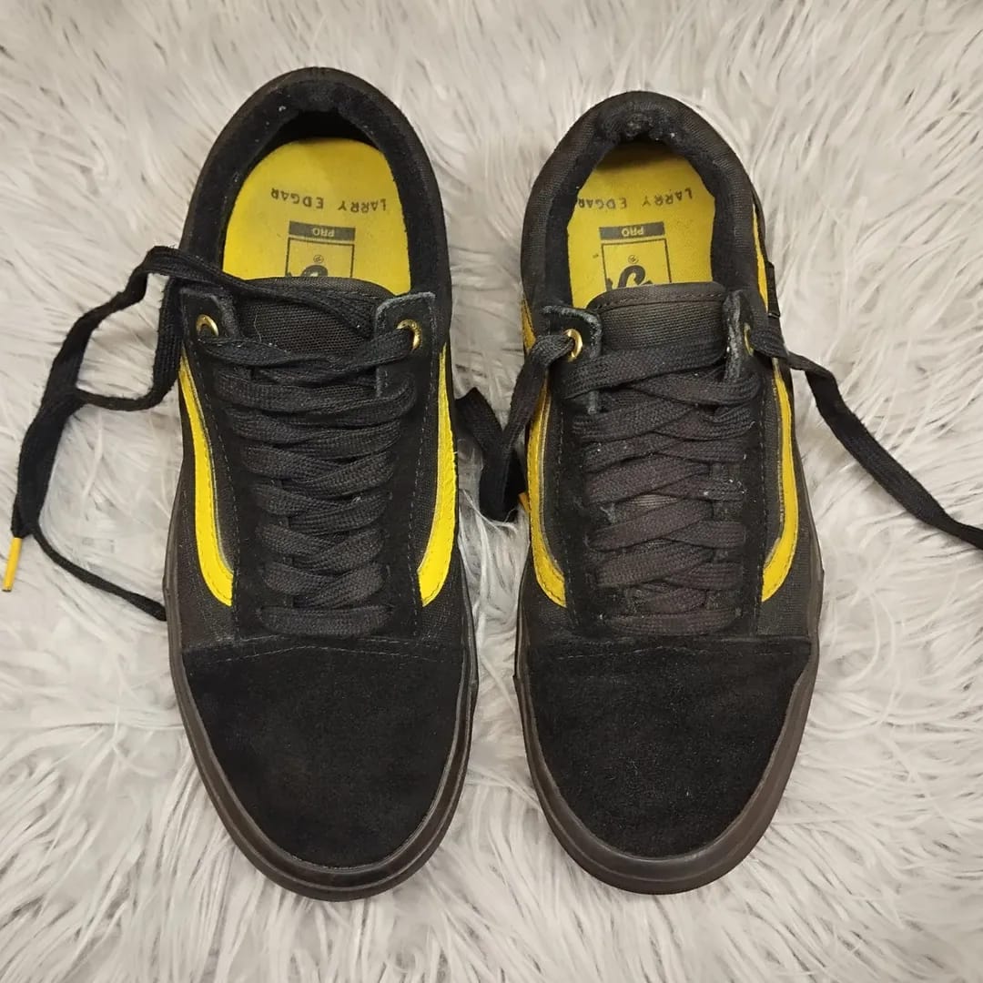 Black and gold low rise vans